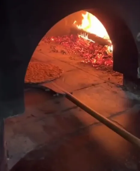 The fire and embers in Sardunya’s wood oven