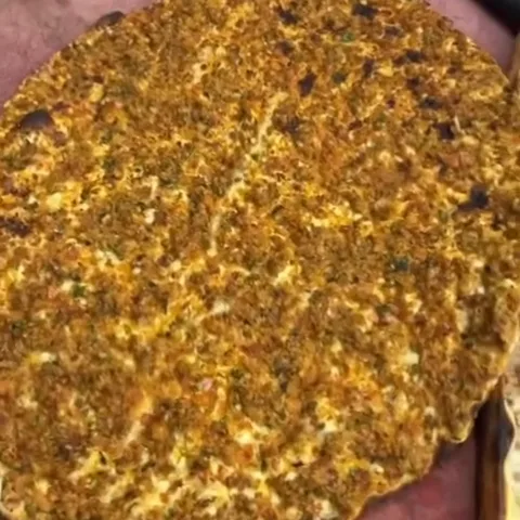 Close-up of a lahmacun fresh from the oven
